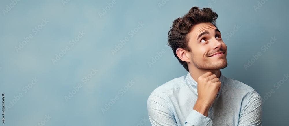 Poster youthful man daydreaming and looking towards empty space