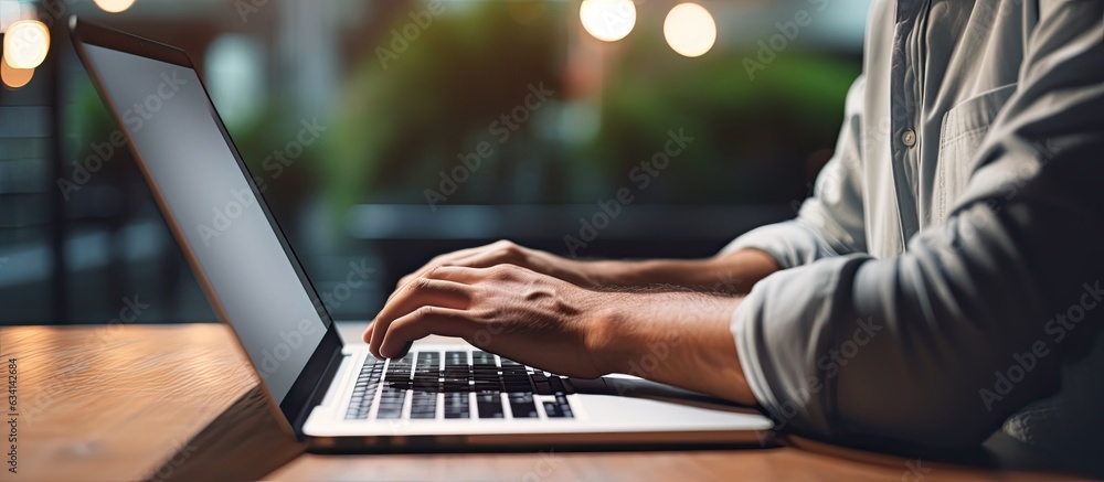 Aufkleber Man using laptop with empty screen for advertising text message in office