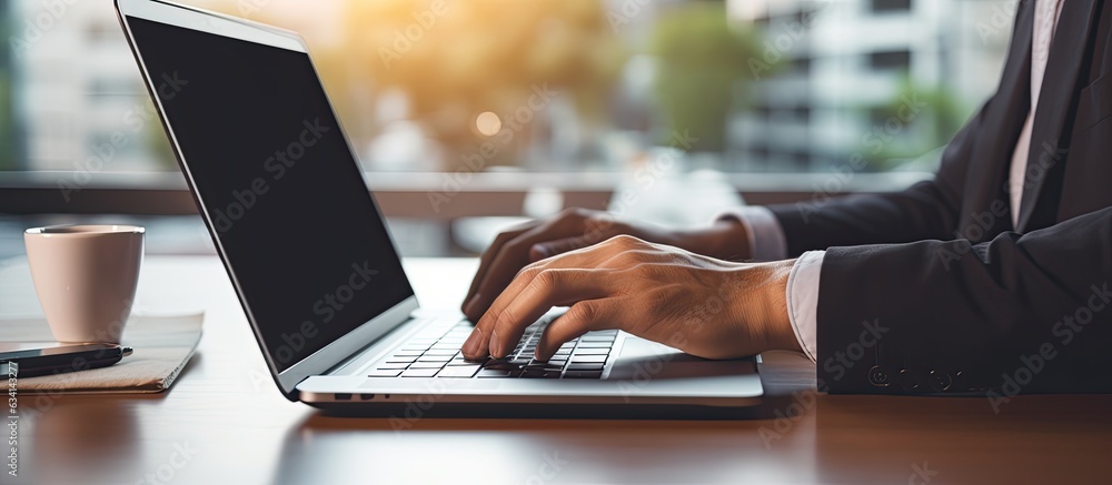 Aufkleber Man using laptop with empty screen for advertising text message in office