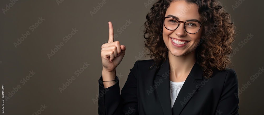 Poster a happy white woman with a professional look and eyewear pointing with her hand while smiling at the