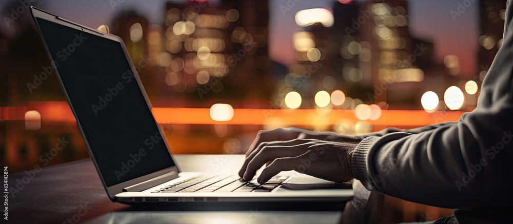 Aufkleber young man using laptop at night with blurred bokeh background horizontal image size with space for t