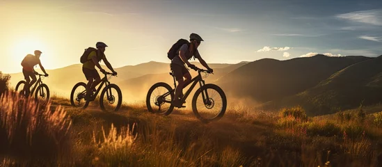Deurstickers Ochtendgloren Three friends on electric bicycles enjoying a scenic ride through beautiful mountains
