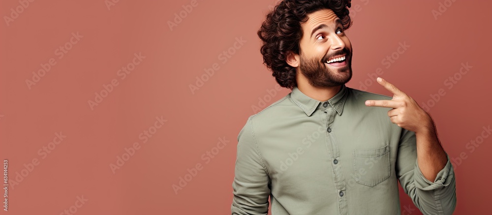 Aufkleber young man with a great idea pointing to lateral copy space looks happy and surprised