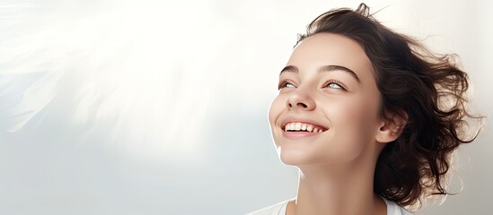 Teen girl looking up with a smile blank copy space over light background