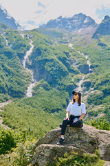 girl on the background of mountains with waterfalls