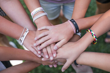 Team of children put hands together.Peaceful Protest kids group and protester unity in a fist of diverse people connected together as a nonviolent resistance symbol of justice and fighting