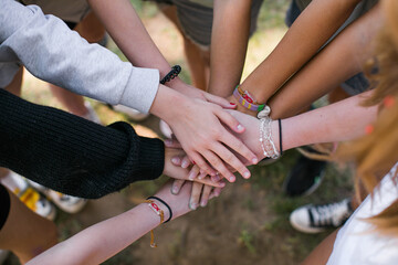 Team of children put hands together.Peaceful Protest kids group and protester unity in a fist of diverse people connected together as a nonviolent resistance symbol of justice and fighting