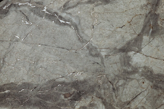 Grey marble background with gold pattern on surface. Texture of stone slab. Graphic abstract background. Ceramic countertop.Flat lay. Top view. Copy space.