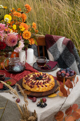 Thanksgiving dinner preparation. Table with pumpkin, autumn season pie. Decorated kitchen in Halloween season. Cooking celebration feast. Fall seasonal table.