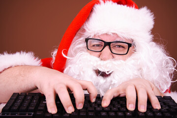 Funny Santa Claus reads online mail. Different emotions.