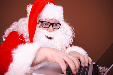 Funny Santa Claus reads online mail. Different emotions.