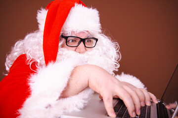 Funny Santa Claus reads online mail. Different emotions.