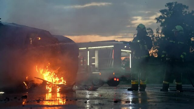 Portrait of a heroic fireman in a protective suit. Firefighter in fire fighting operation.