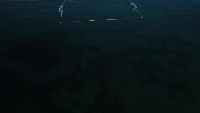 water polo field by the sea, by the concrete jetty, sunny day, summer, calm sea, view from a drone