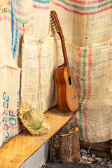 old guitar resting on a corner of sacks