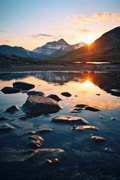 sunset on the lake with mountains in the background