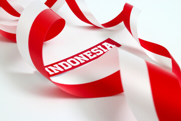 Fototapeta na wymiar The word INDONESIA written on paper with a red and white ribbon, and empty copy space, isolated on a white background