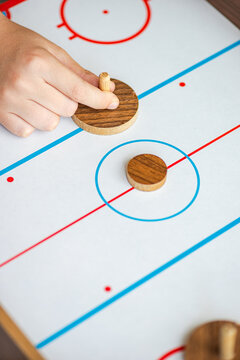 Top view anonymous playing air hockey
