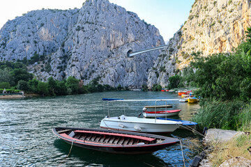 Boats, boats on the river Cetina in the port of Omis overlooking the high mountains