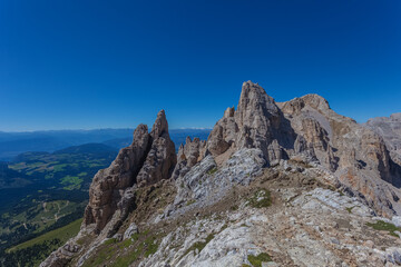Awesome summer dolomite rocky panorama with innumerable spiers in the Latemar Massif, UNESCO world heritage site. The main pinnacle is named Torre di Pisa. Trentino-Alto Adige, Italy, Europe