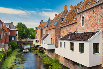 Fototapeta na wymiar The so-called hanging kitchens of medieval buildings along a canal in the town of Appingedam, province of Groningen, the Netherlands 