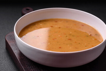 Delicious fresh vegetable soup with carrots, peppers, potatoes and onions