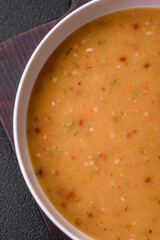 Delicious fresh vegetable soup with carrots, peppers, potatoes and onions