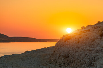 Beautiful sunset colors over the mountains on the island of Pag, Croatia. Empty islands in the evening over the Adriatic Sea, summer sunset