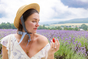 Portrait of a young woman in a straw hat on a lavender field