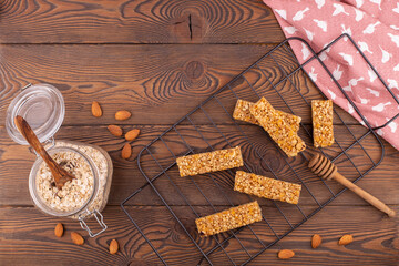 Top view of cereal muesli bar with nuts and honey on a wooden table. Healthy sweet dessert snack