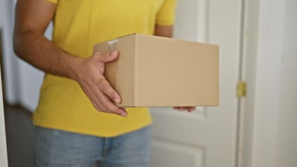Young latin man receiving package at home