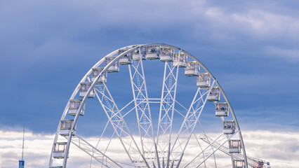 Ferris Wheel of Budapest, Hungary. Cloudy skies and a Ferris wheel. Isolated amusement vehicle.