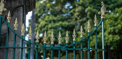 Closeup Panorama of a Teal and Gold Gilded Fence.