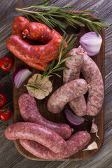Cutting board with many raw sausages