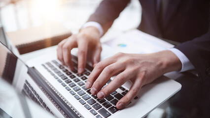 businessman finger typing on computer keyboard in office