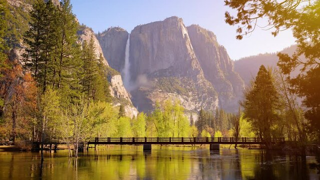 The Merced River as it runs through Yosemite National Park in California with Yosemite Falls in the background.