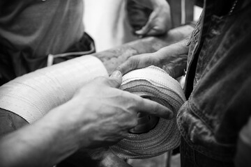 A roll of Kevlar tape is being prepared by a composite repair firm to be impregnated with epoxy.