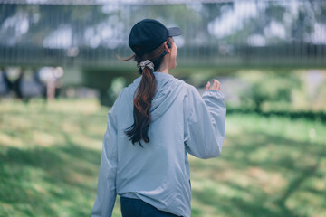 Stylish female runners in modern attire, discover serenity. Reenergize amid jogging the parkway.