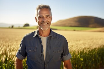Middle aged caucasian farming smiling on his farm field