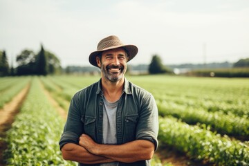 Naklejka na ściany i meble Middle aged caucasian farming smiling on his farm field