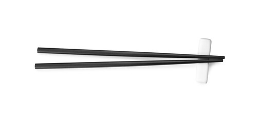 Pair of black chopsticks with rest isolated on white, top view