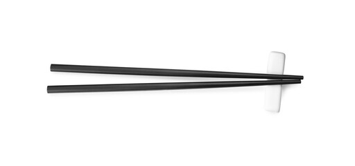 Pair of black chopsticks with rest isolated on white, top view