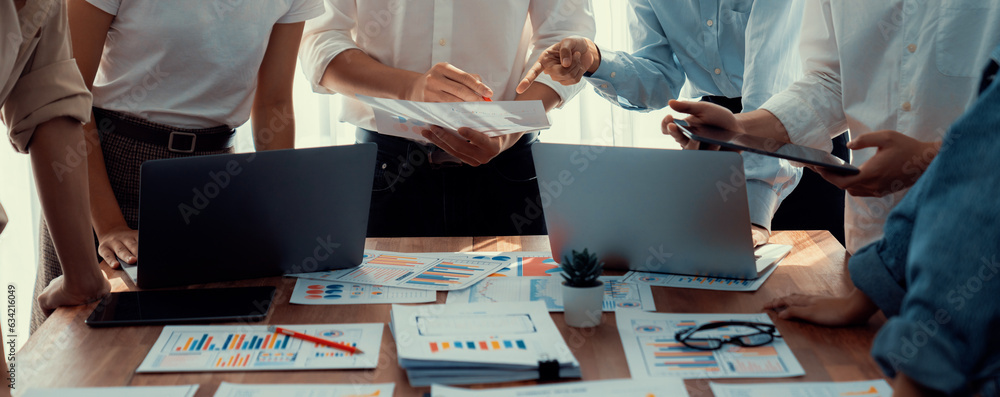 Aufkleber Analyst team utilizing BI Fintech to analyze and pointing at financial dashboard paper office. Businesspeople examining report paper on table for business insight. Panorama shot. Scrutinize