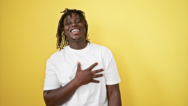 African american man laughing a lot over isolated yellow background