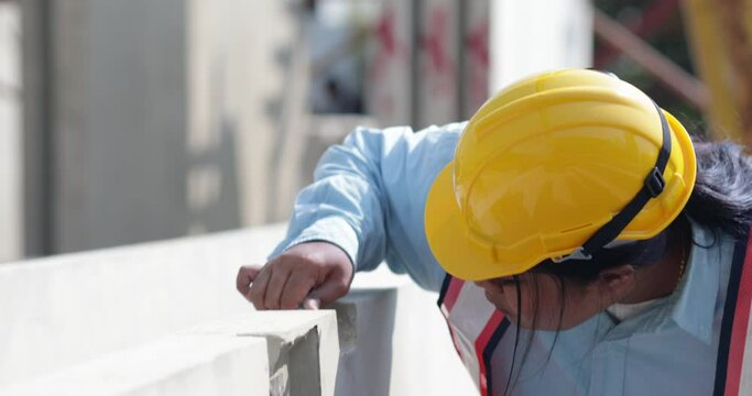 African american women foreman checking quality of prefabricated concrete wall. Plus size female worker wearing safety hardhat working at heavy Prefabricated concrete walls manufacturing factory