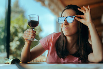 Expert Sommelier Checking a Glass of Wine for Clarity and Color. Woman trying an beverage in a...