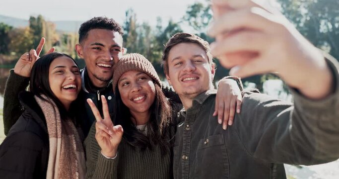 Happy people, friends and nature for selfie, photography or outdoor memory with peace sign together. Group smile in happiness for travel, holiday weekend or social media photograph in winter forest