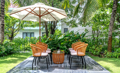 bamboo and rattan tables and chairs in a quiet and green tropical garden