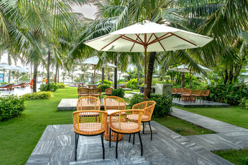 bamboo and rattan tables and chairs in a quiet and green tropical garden