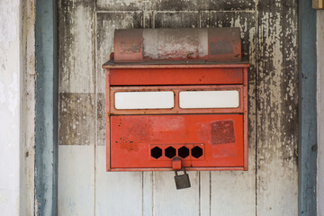 Red post box on wood wall